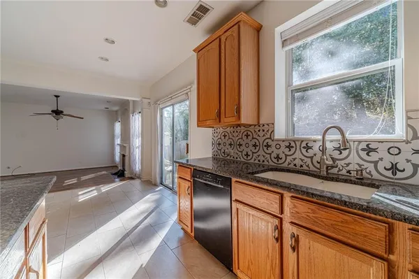 a kitchen with stainless steel appliances granite countertop a sink stove and cabinets