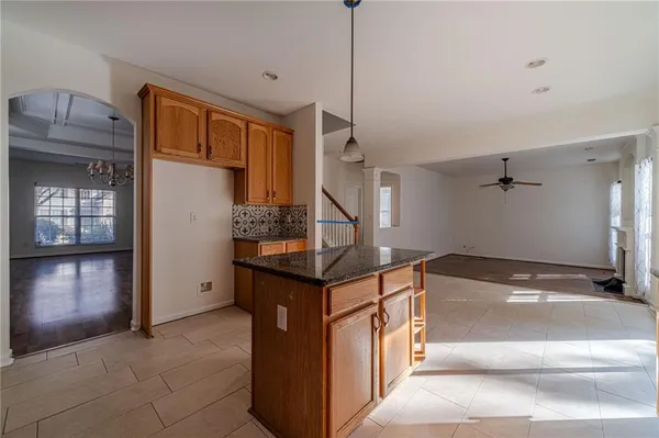 a kitchen that has a lot of cabinets and wooden floor