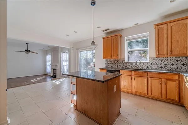 a kitchen with stainless steel appliances granite countertop a sink and cabinets