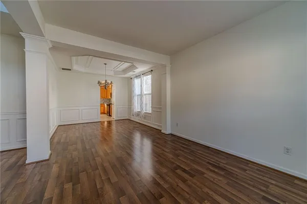 a view of an empty room and wooden floor