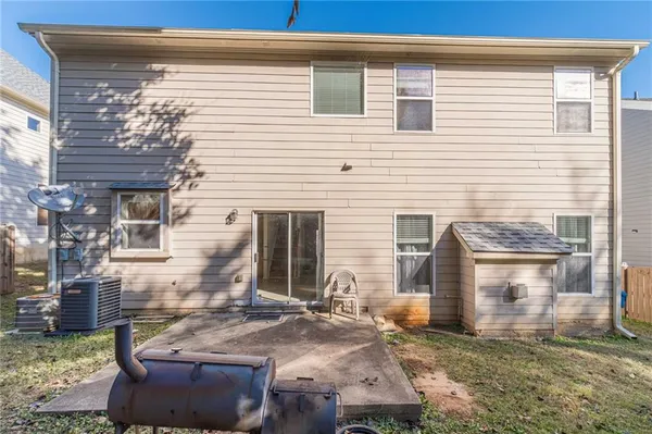 a backyard of a house with yard and outdoor seating