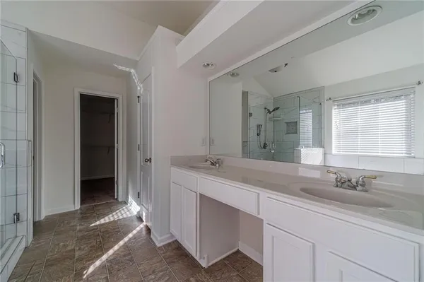 a bathroom with double sink and a mirror
