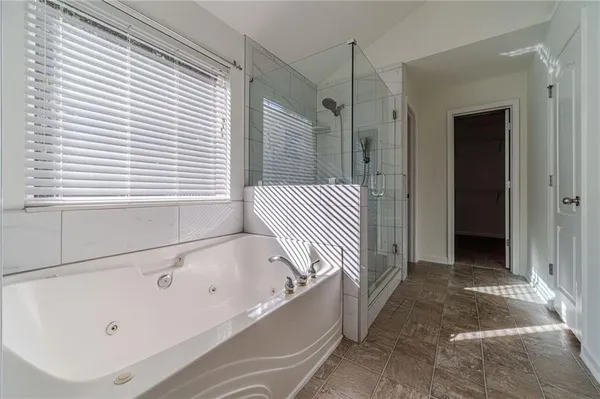 a bathroom with a bathtub and shower