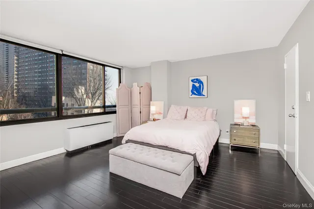 a bedroom with a large bed and a large window