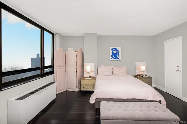 a bedroom with a large bed and a dresser