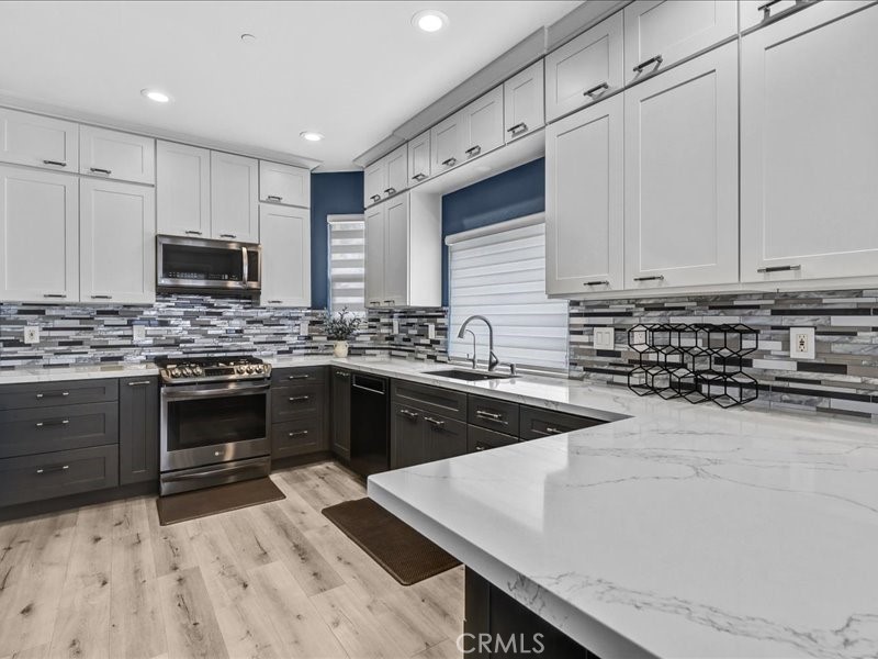 3405 South El Camino Real, Unit A San Clemente, CA 92672 - Photo 11 of 58 a kitchen with sink a stove and cabinets