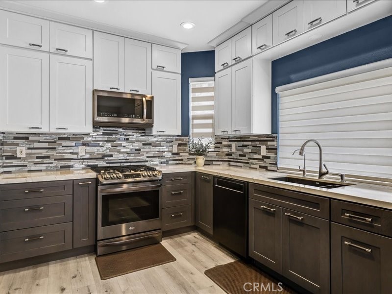 3405 South El Camino Real, Unit A San Clemente, CA 92672 - Photo 13 of 58 a kitchen with stainless steel appliances granite countertop a sink stove and microwave