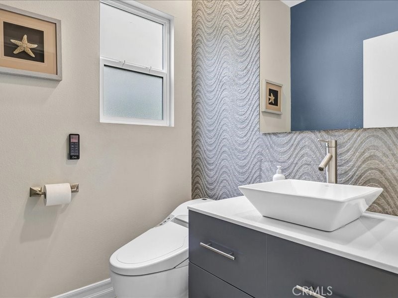 3405 South El Camino Real, Unit A San Clemente, CA 92672 - Photo 14 of 58 a bathroom with a toilet a sink and mirror