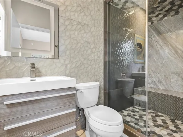 a bedroom with a bed and painting on the wall