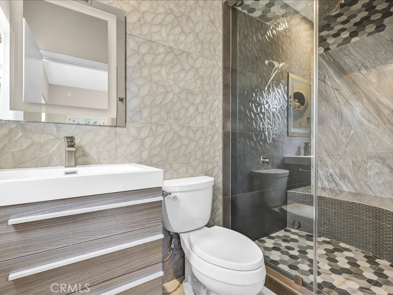 3405 South El Camino Real, Unit A San Clemente, CA 92672 - Photo 17 of 58 a bathroom with a sink a toilet a shower and a mirror