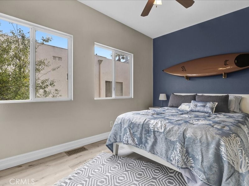 3405 South El Camino Real, Unit A San Clemente, CA 92672 - Photo 19 of 58 a bedroom with a bed and painting on the wall