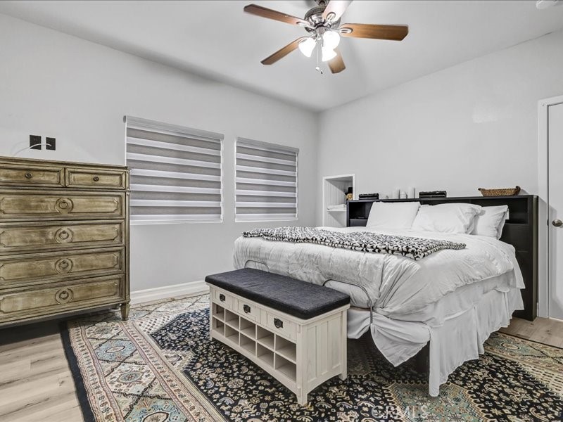 3405 South El Camino Real, Unit A San Clemente, CA 92672 - Photo 21 of 58 a bedroom with a bed and a chandelier