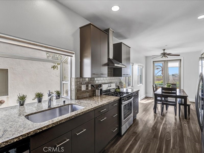 3405 South El Camino Real, Unit A San Clemente, CA 92672 - Photo 33 of 58 a kitchen with granite countertop a sink stove and cabinets
