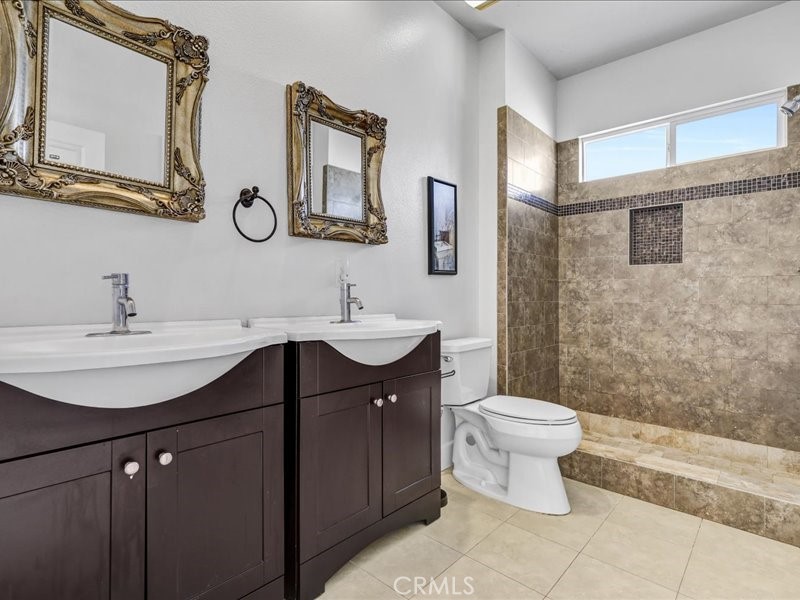 3405 South El Camino Real, Unit A San Clemente, CA 92672 - Photo 39 of 58 a bathroom with a toilet sink and mirror