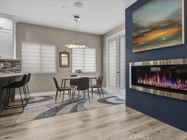 a dining room filled chandelier and kitchen view