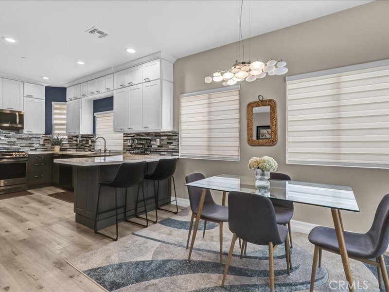 3405 South El Camino Real, Unit A San Clemente, CA 92672 - Photo 10 of 58 a dining room filled chandelier and kitchen view