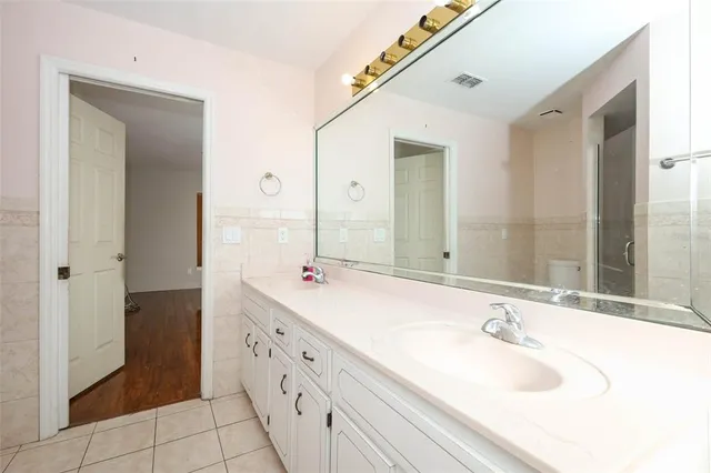 a bathroom with a double vanity sink and mirror