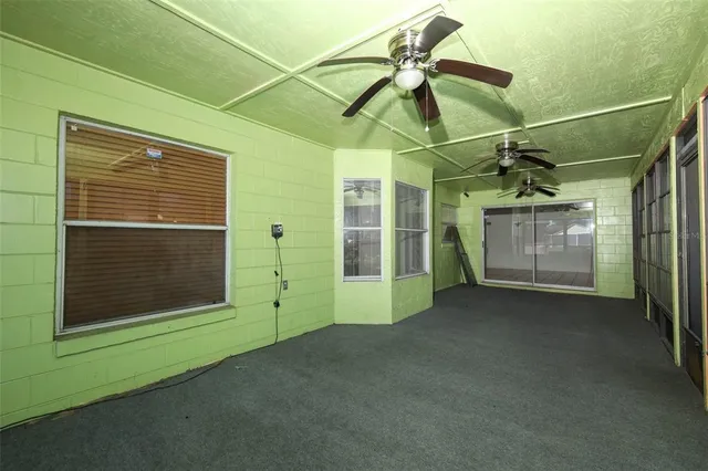 a view of an empty room with a fireplace and a window
