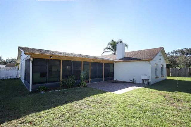 a backyard of a house with lots of green space and fountain