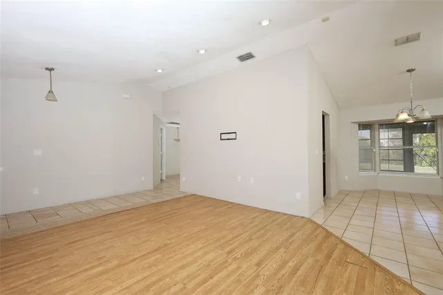 a view of an empty room with glass door