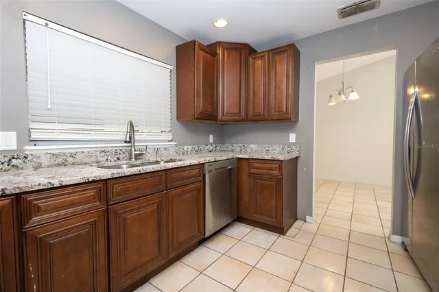 a kitchen with a sink and a refrigerator