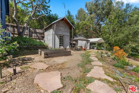 a view of backyard with a table and chairs