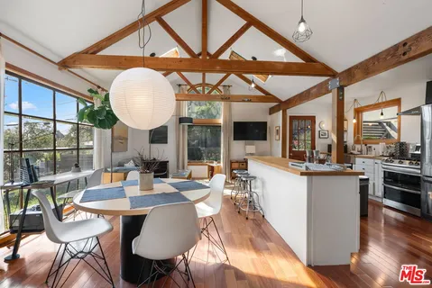 a view of a dining room with furniture window and wooden floor