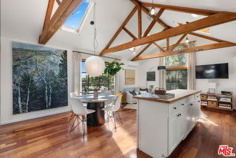 a view of a dining room with furniture wooden floor and a chandelier