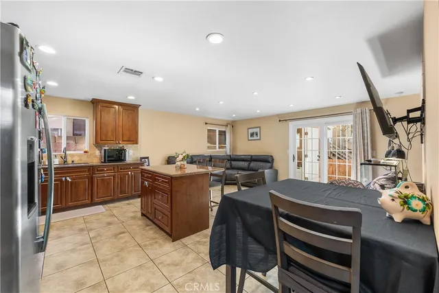 a kitchen with stainless steel appliances granite countertop wooden cabinets a stove top oven a sink and dishwasher