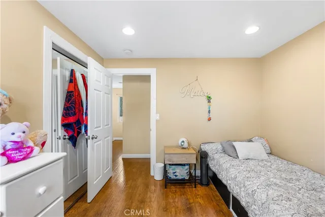 a bedroom with a bed and a flat screen television