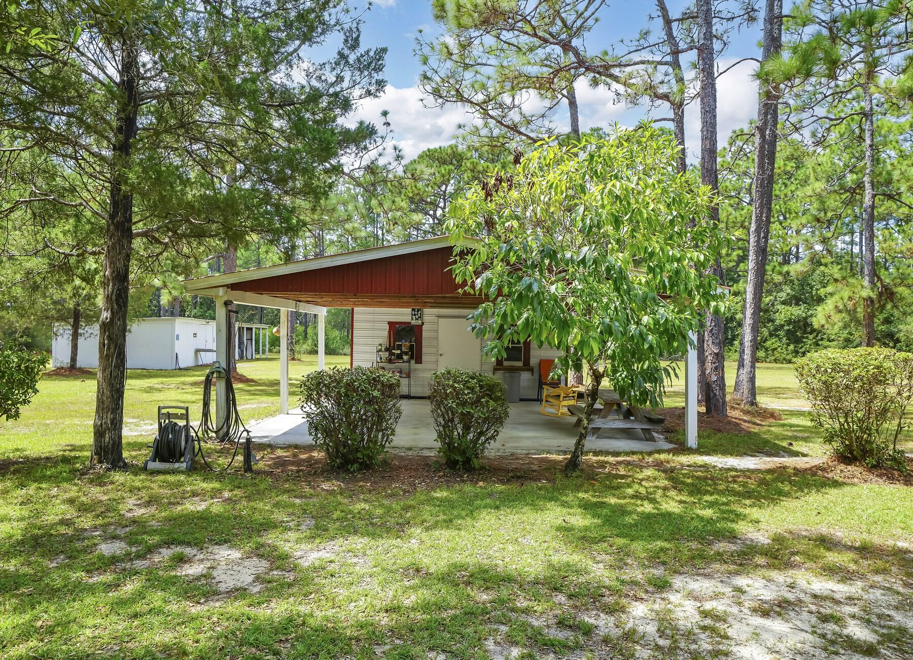 14034 331 Business Freeport, FL 32439 - Photo 14 of 44 a view of a house with backyard and a tree