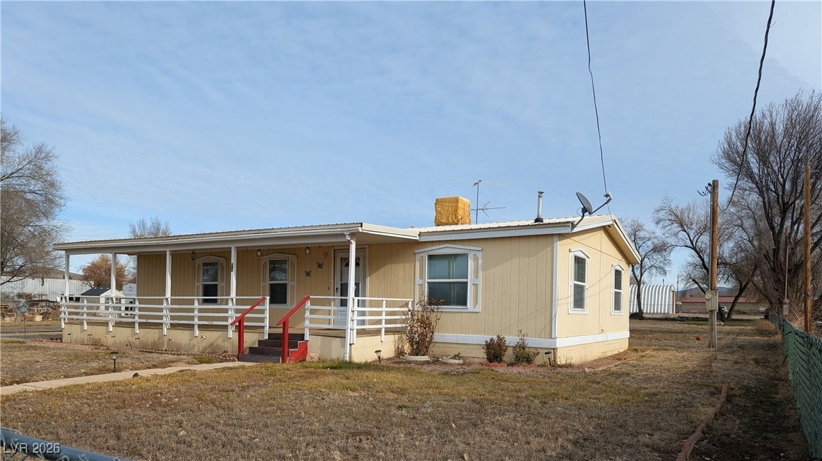 50 North 2nd Street Panaca, NV 89042 - Photo 1 of 35 Manufactured / mobile home featuring covered porch and a chimney