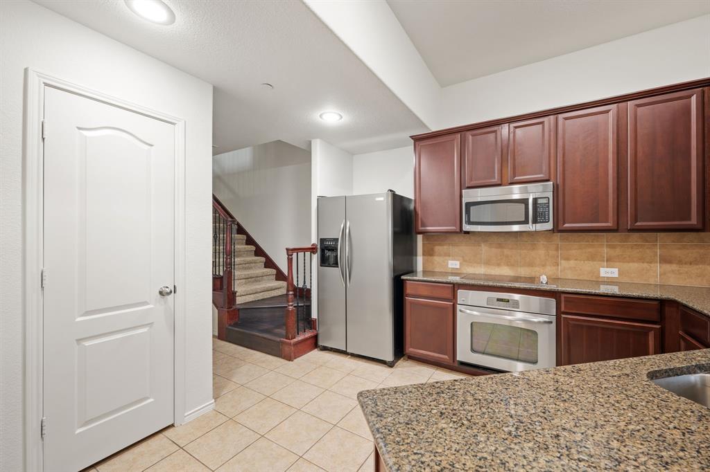 1013 Lucy Lane Allen, TX 75013 - Photo 13 of 30 a kitchen with stainless steel appliances granite countertop a refrigerator and a sink