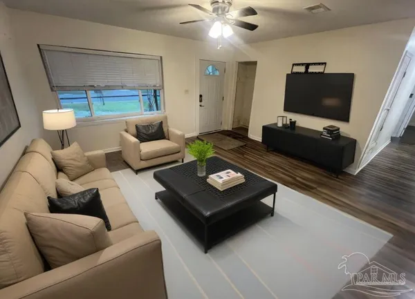 a living room with furniture and a flat screen tv