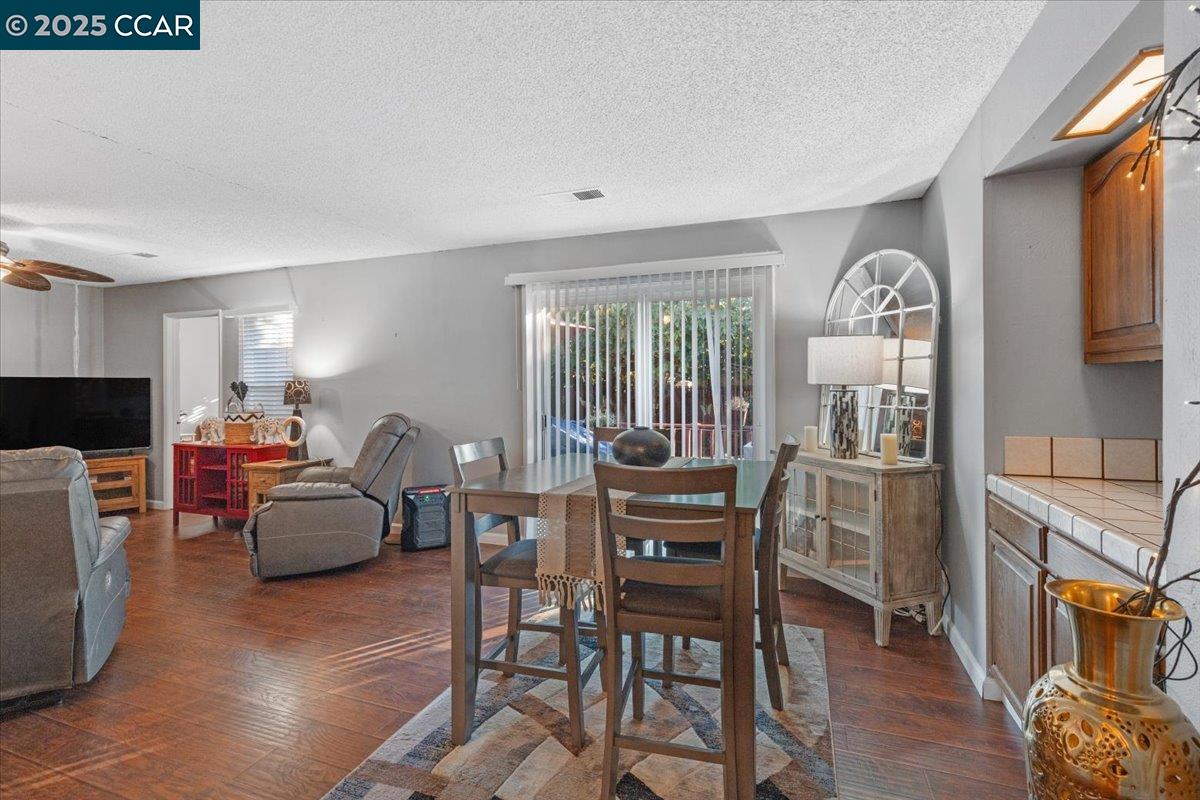 2644 East Olivera Road Concord, CA 94519 - Photo 18 of 42 a living room with furniture a fireplace and a dining table with wooden floor