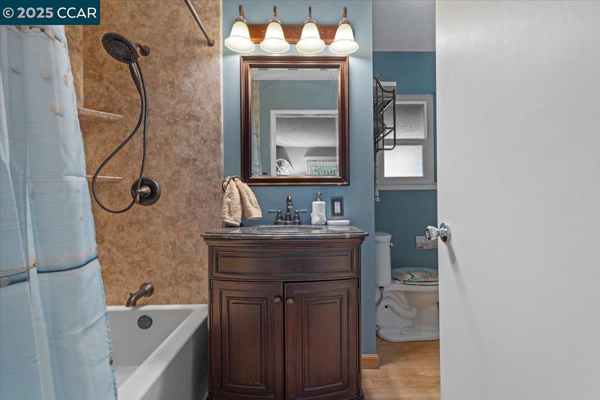 2644 East Olivera Road Concord, CA 94519 - Photo 21 of 42 a bathroom with a granite countertop sink a mirror and shower