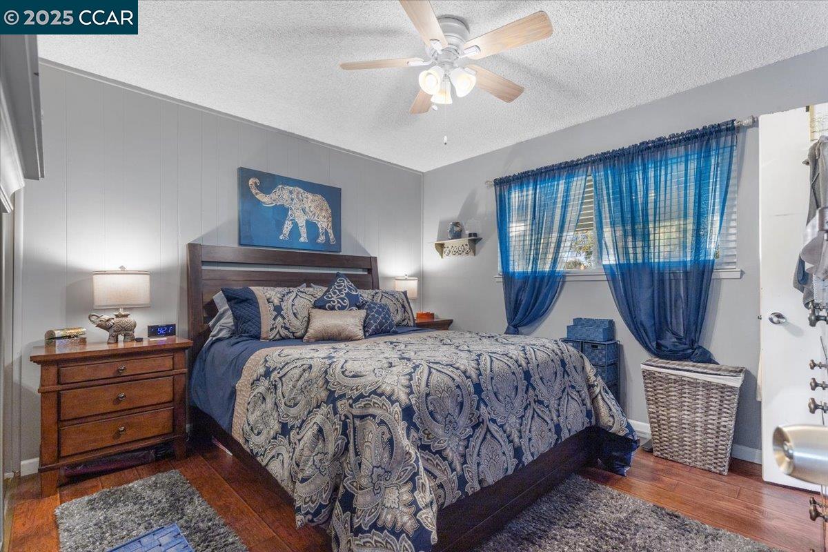 2644 East Olivera Road Concord, CA 94519 - Photo 23 of 42 a bedroom with a bed and wooden floor