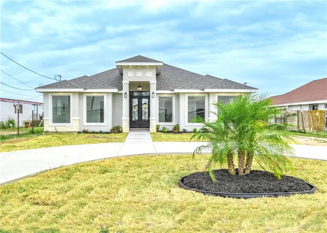 a front view of a house with a yard