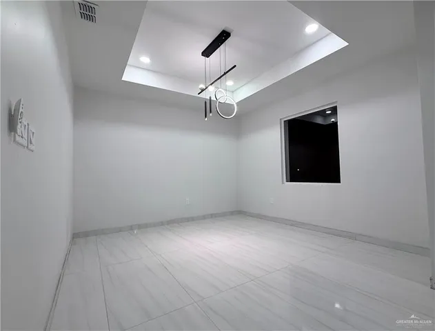 an empty room with a ceiling fan and a window