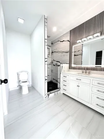 a spacious bathroom with a double vanity sink and a mirror