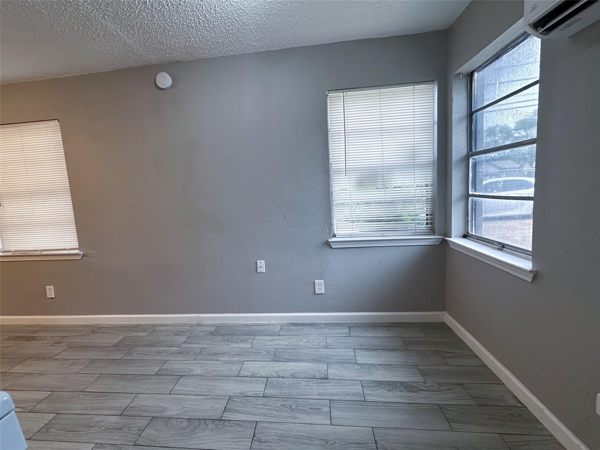5418 Weaver Road, Unit A Houston, TX 77016 - Photo 4 of 11 a view of an empty room with wooden floor and a window
