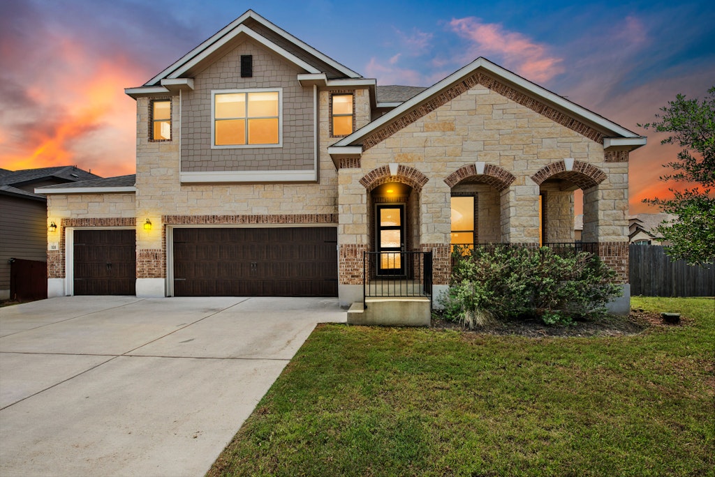 a front view of a house with a yard and garage