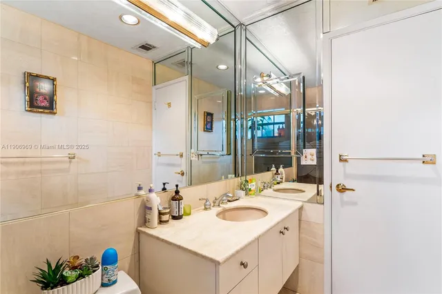 a bathroom with a sink vanity tub and shower