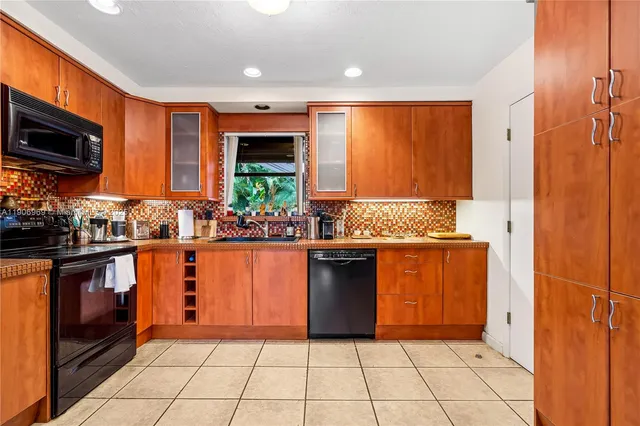 a kitchen with stainless steel appliances granite countertop a refrigerator oven a sink dishwasher and granite countertops