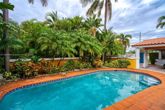 a view of swimming pool with an outdoor seating