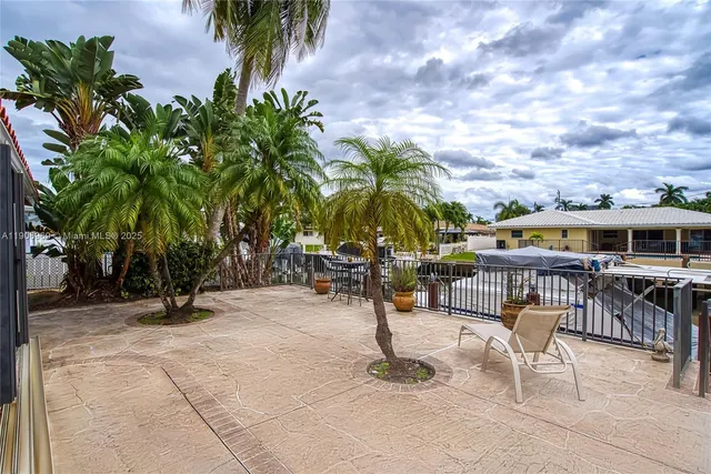 a view of a house with swimming pool and sitting area
