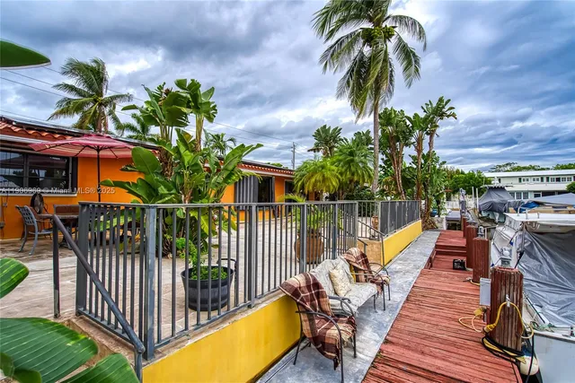 a view of front yard with a plants and palm trees