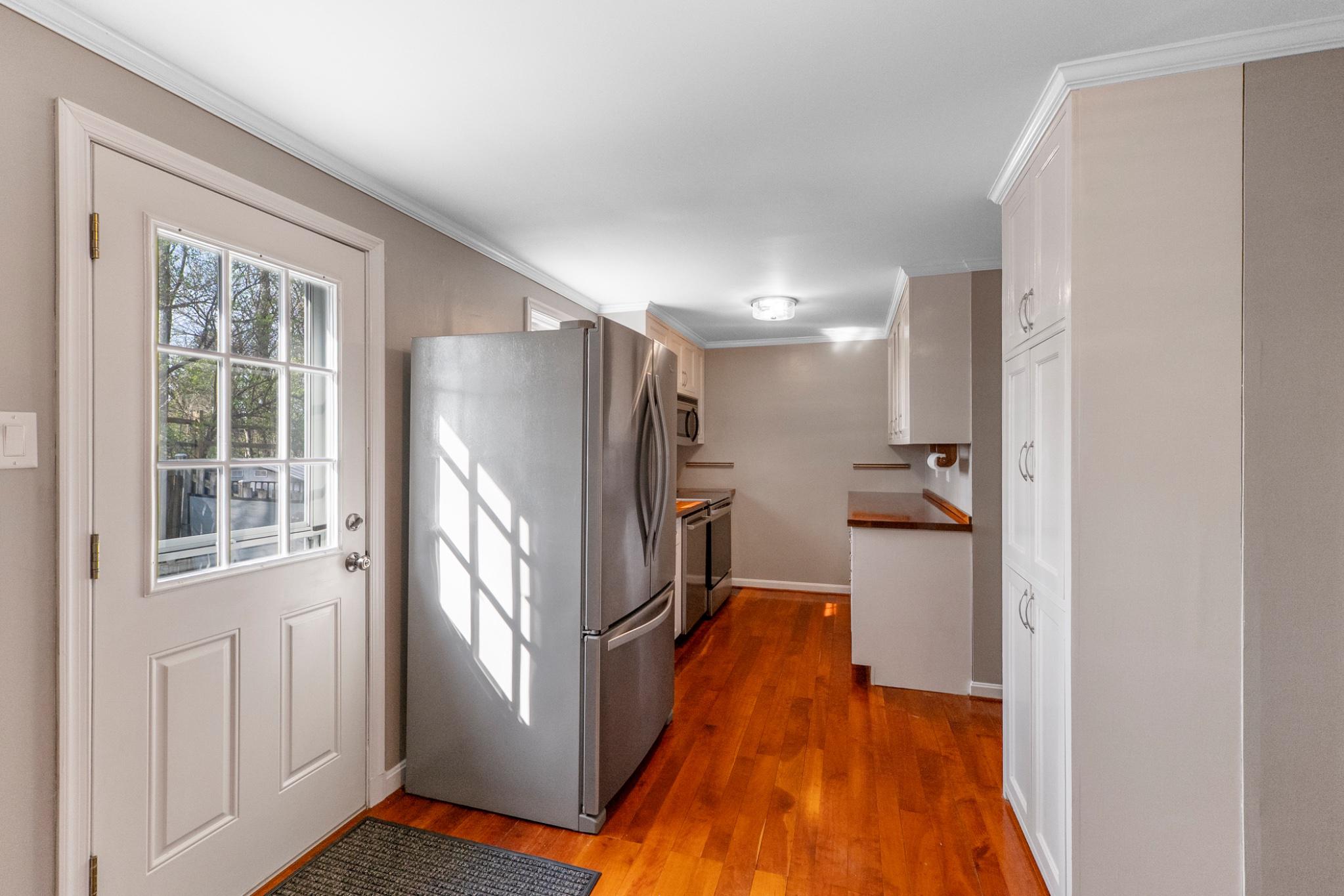 9918 Canvasback Way Damascus, MD 20872 - Photo 11 of 32 a view of a refrigerator in kitchen and wooden floor