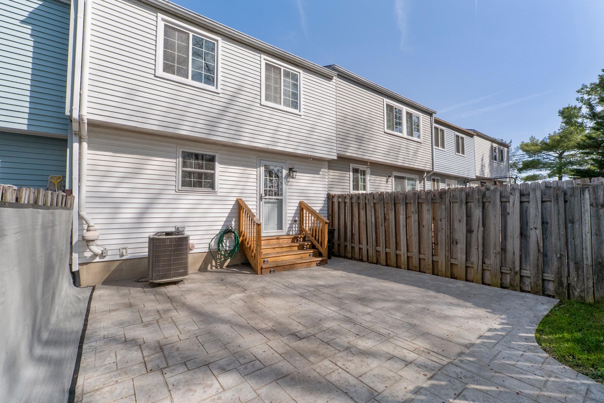 9918 Canvasback Way Damascus, MD 20872 - Photo 30 of 32 a view of a patio with table and chairs and wooden fence