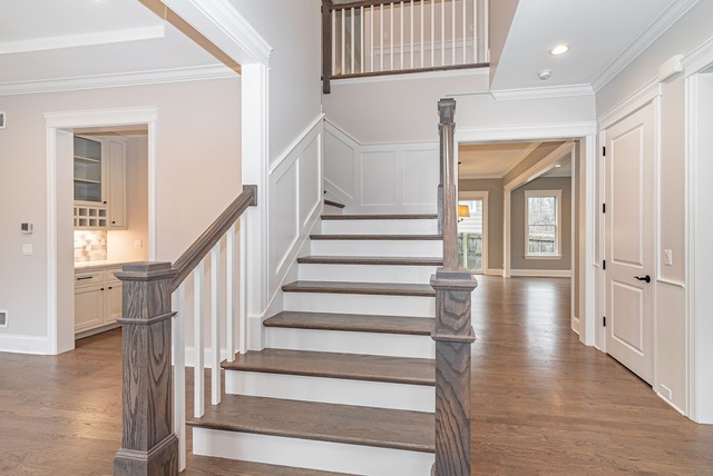 1360 Kenton Road Deerfield, IL 60015 - Photo 8 of 29 a view of staircase with white walls and a window